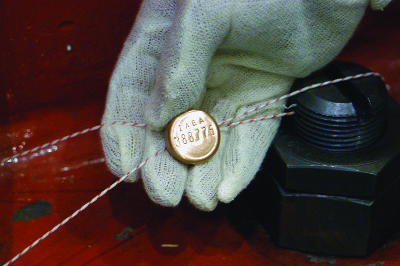 IAEA metal seal. Photo by Dean Calma/IAEA.