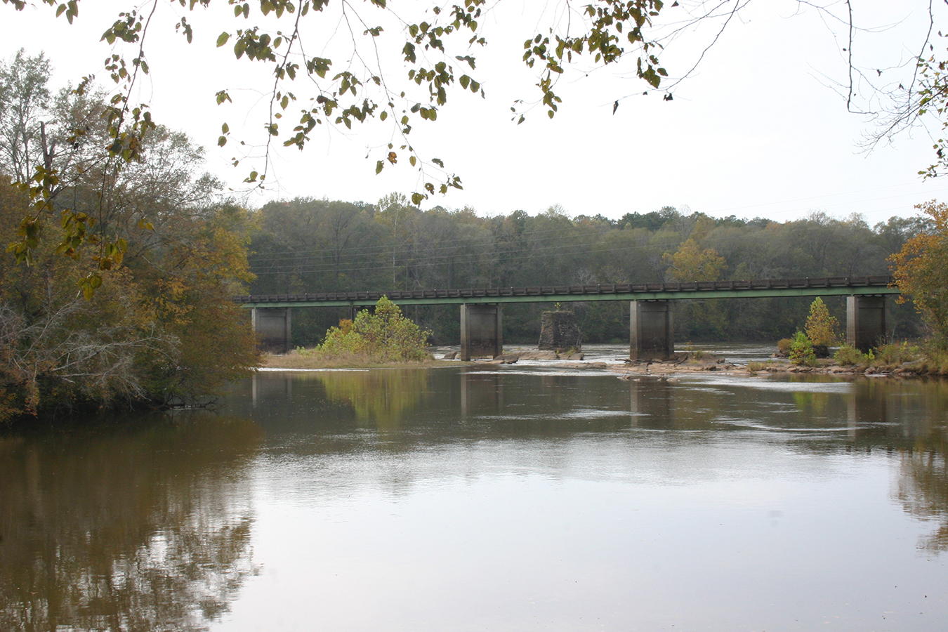 An old bridge falls into the Tallapoosa River at Horseshoe Bend. A new bridge has been constructed in front of it. Photo by Leigh Bloch.