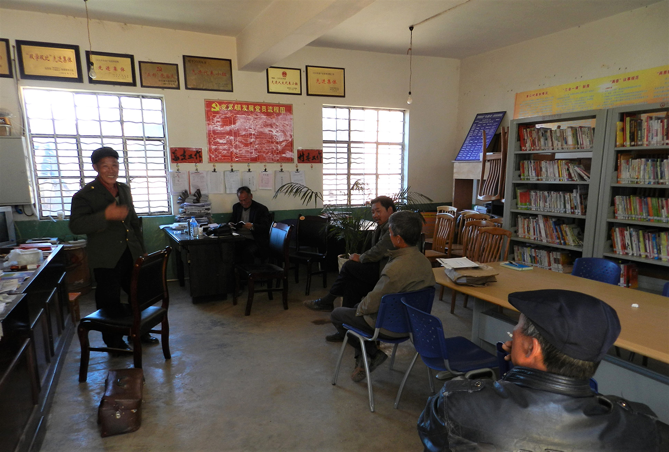 A mediation session is underway in the foyer of a village committee building. Photo by Andrea E. Pia.
