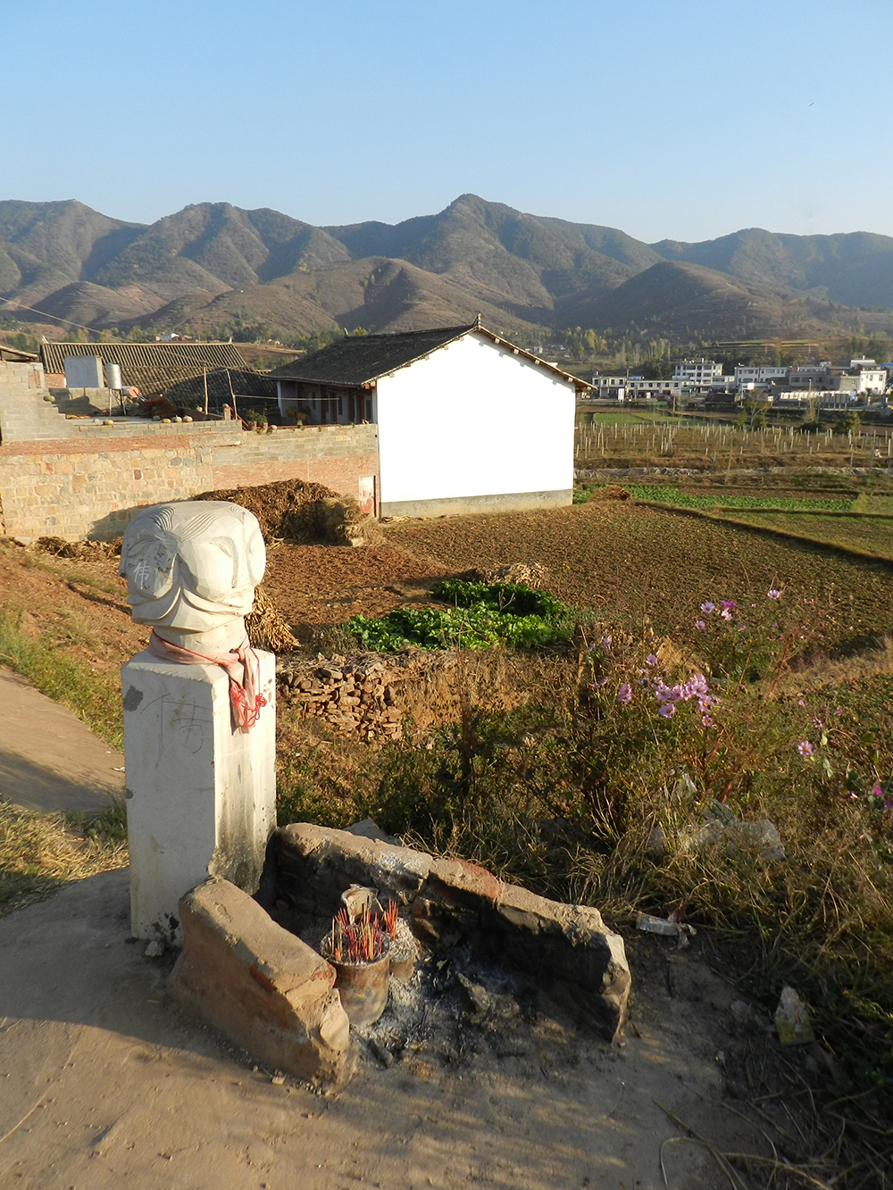 A worship altar devoted to a Chinese crossroads spirit. A Chinese character can be read across its pillar: “Illegal.” Photo by Andrea E. Pia.