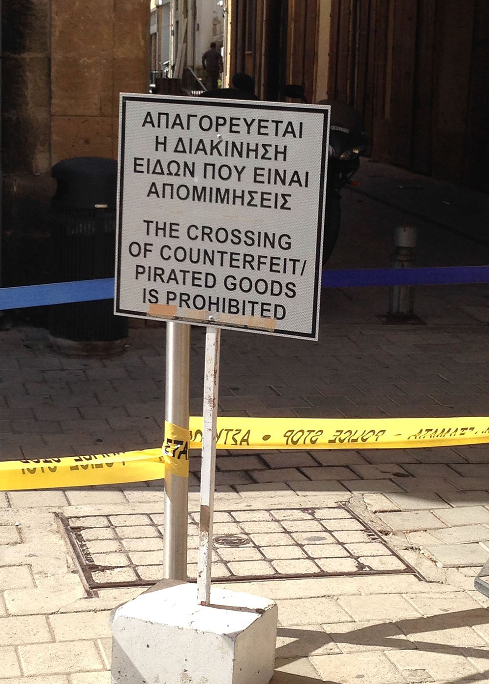 A sign at the Ledra Street checkpoint prohibiting the crossing of counterfeit goods into Nicosia’s south. Photo by Rebecca Bryant.