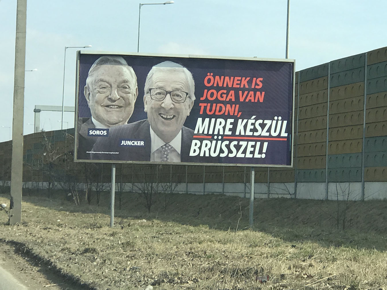 Billboard sponsored by the Hungarian government depicting Juncker conspiring with Soros: “You, too, have the right to know what Brussels is up to!” Photo by Valerie Hopkins.