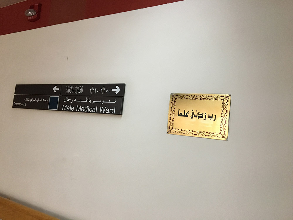 Supplication from Quran Surah Taha (20: 114) on gold frame in hospital hallway. In Arabic, Rabbi Zidni ‘ilma [My Lord, increase me in knowledge]. Photo by Ashwak Sam Hauter.