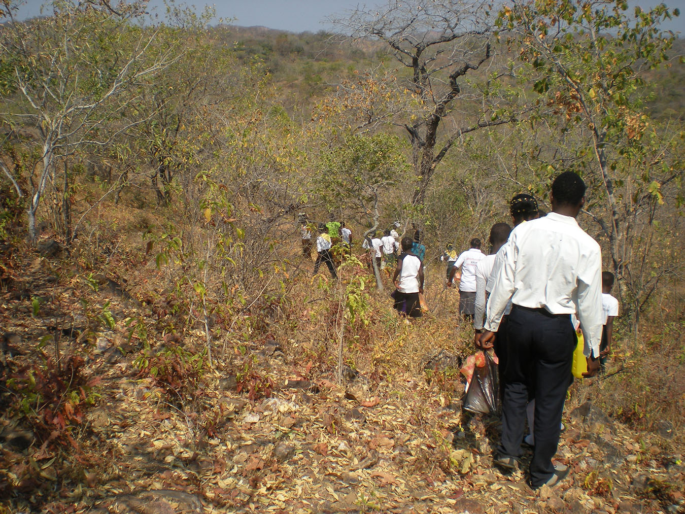 The SDA Pathfinder youth take a day hike through the hills. Outskirts of Mugoda Village, Southern Province, Zambia. Photo by Justin Lee Haruyama.