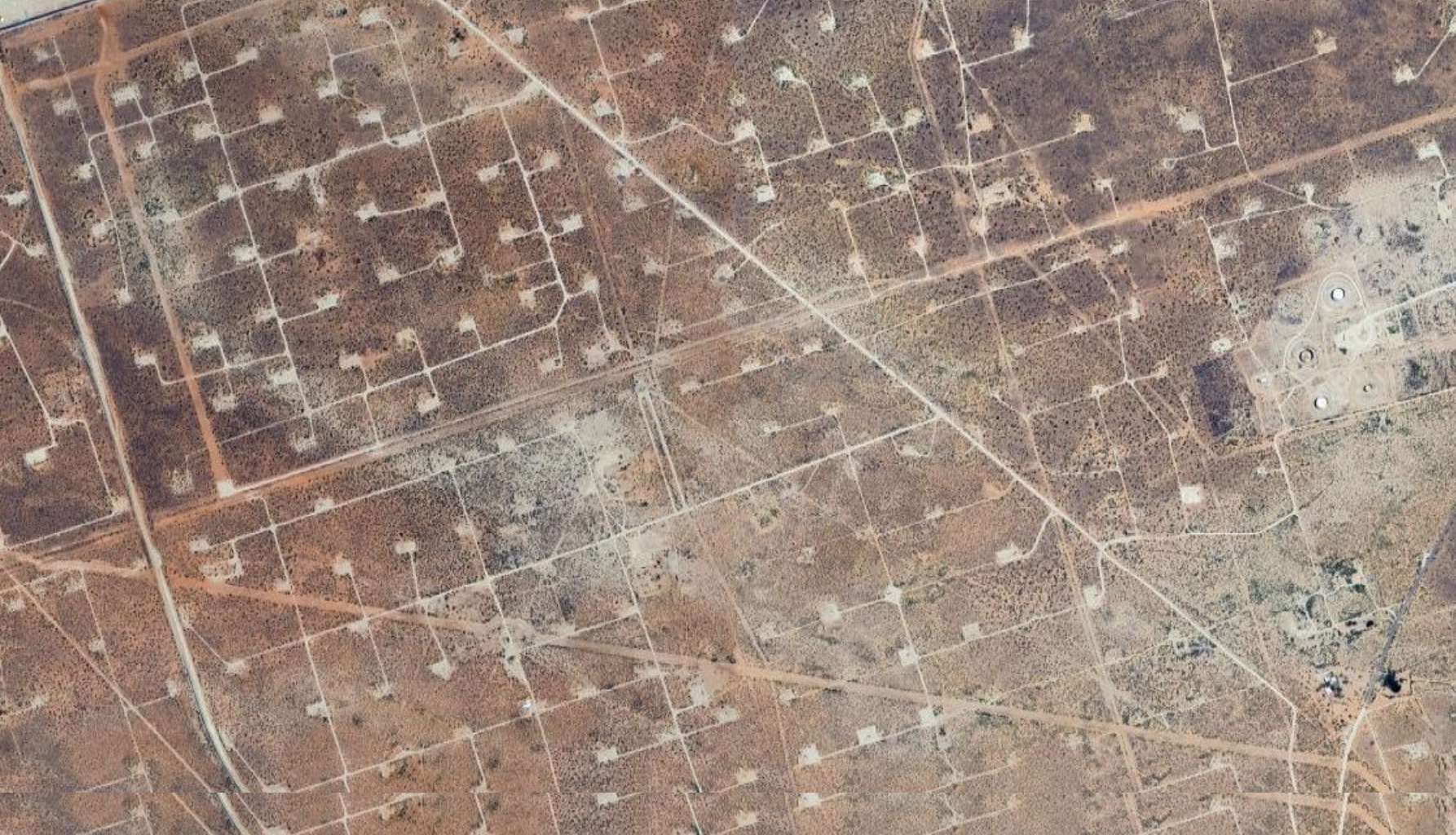 A dense grid of oil wells seen from above.