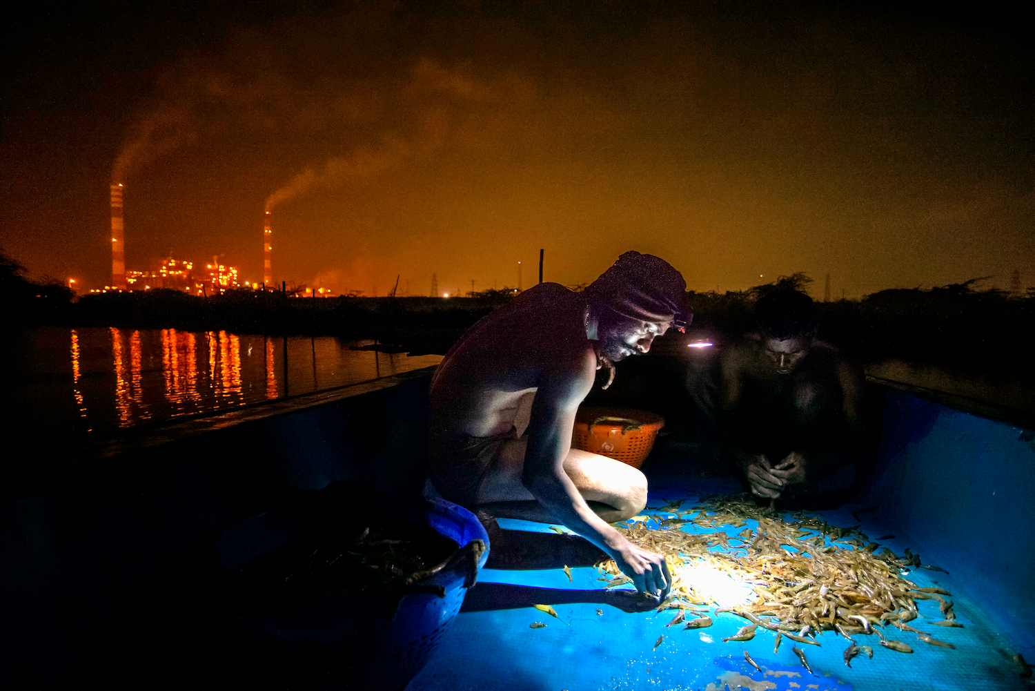 Video footage of Velu practicing Thozil with the power plant in the bakdrop.
