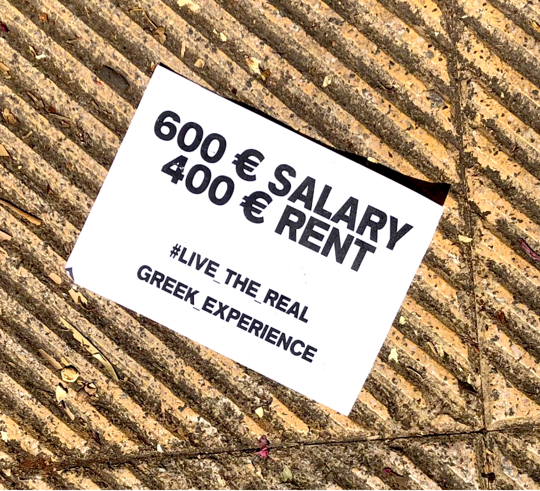 Flyer dropped on the sidewalk raising awareness of the Athenian housing crisis.
