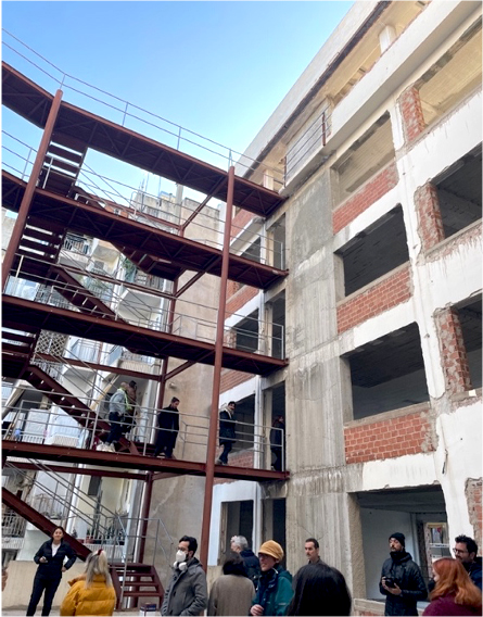 An internal building courtyard with people in it.