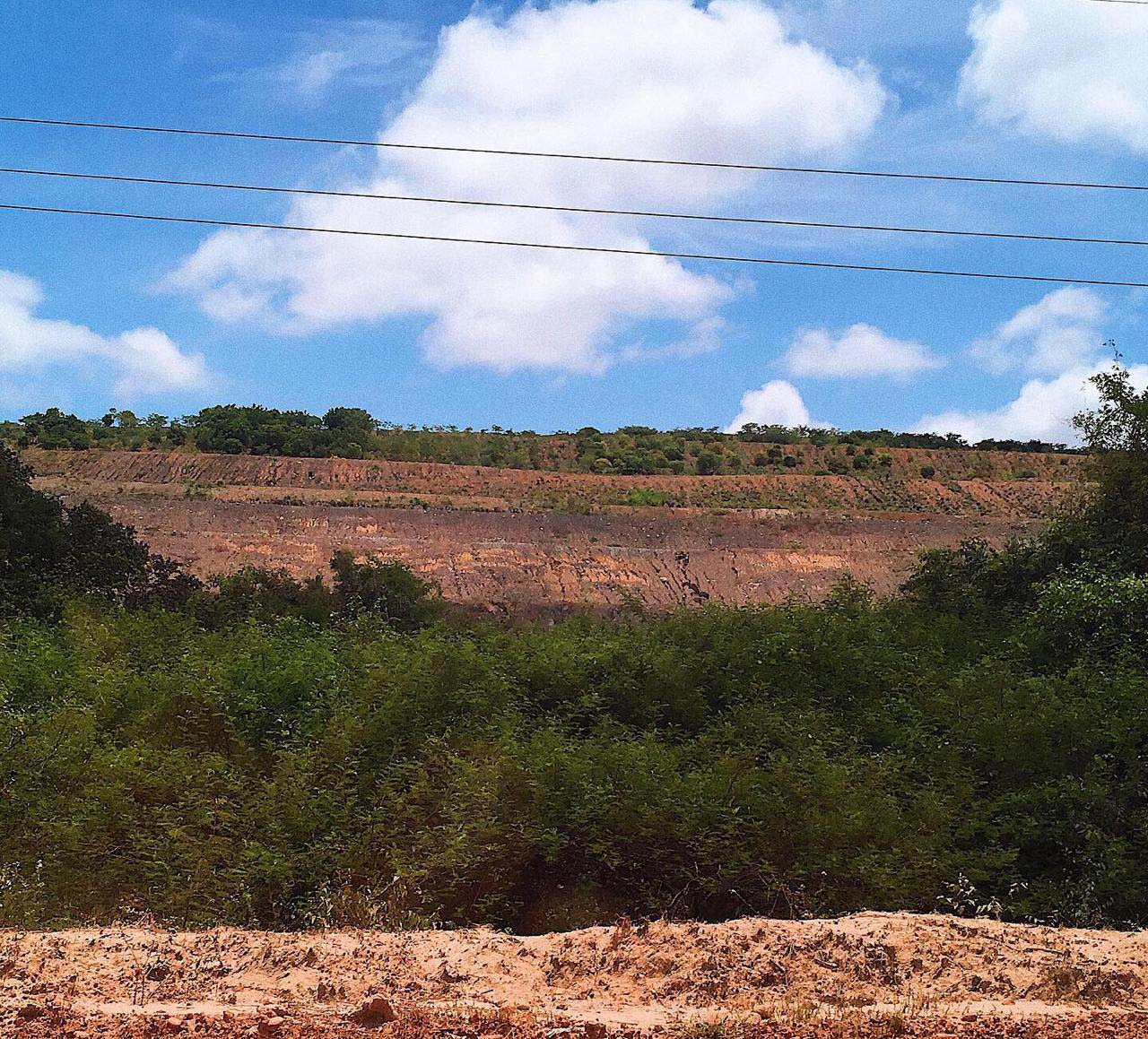 Mountains, made with mining waste, emerge from former savannas.